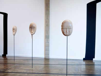 Three masks on poles