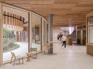 Herzog & de Meuron Children's Hospital in Zurich timber building interior and exterior engulfed in foliage