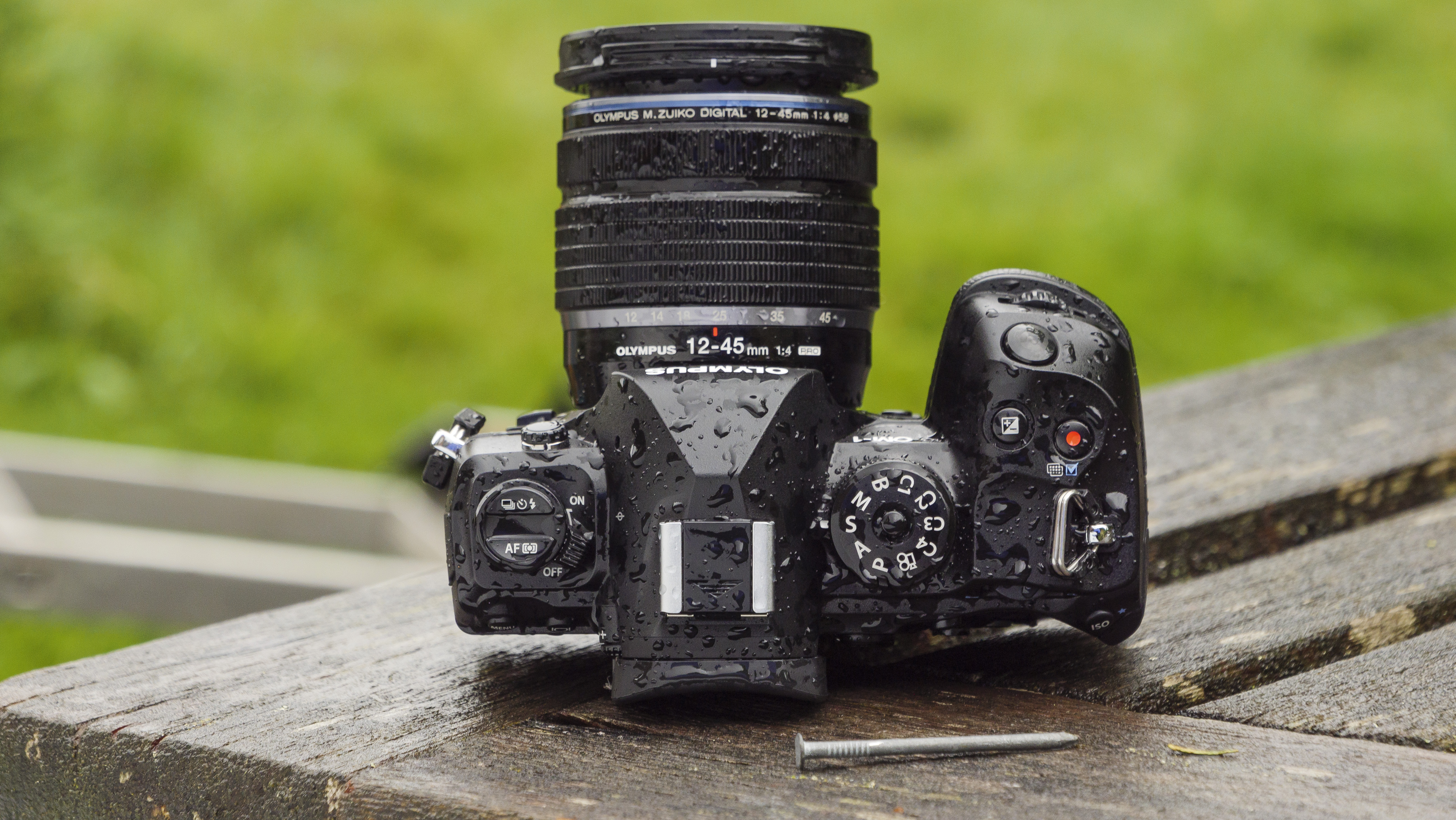 The OM System OM-1 camera on a wooden table