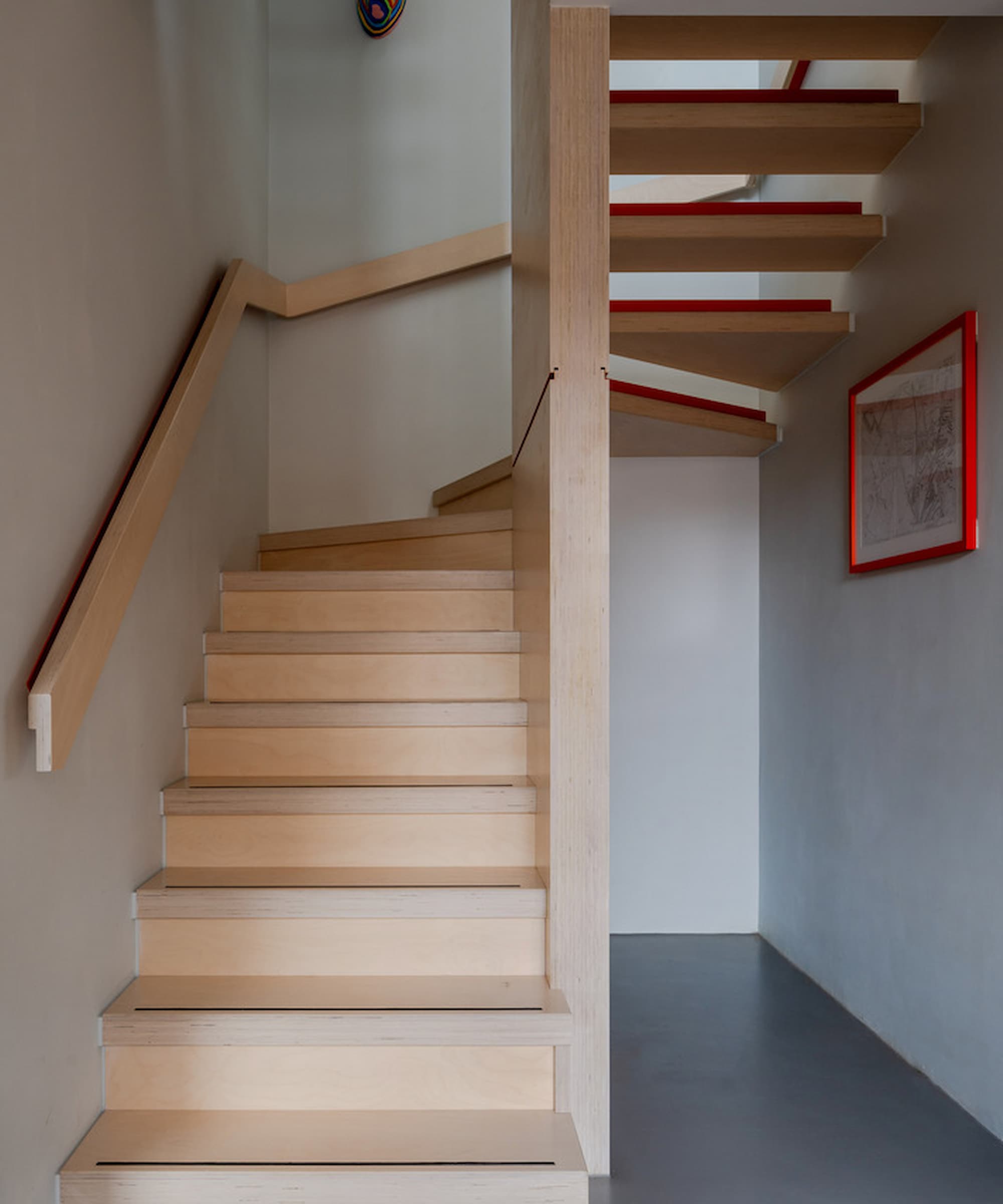 A wooden staircase that wraps round