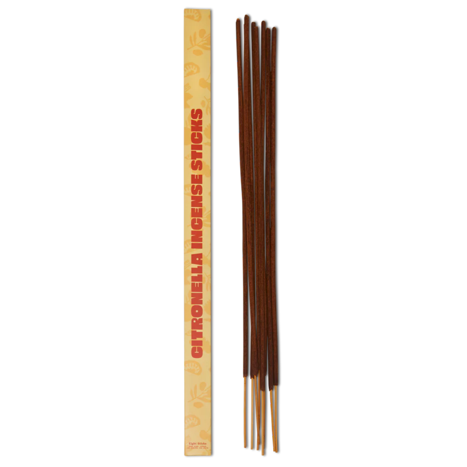 A set of long incense sticks near an incense box patterned in yellow motifs with orange font
