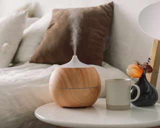 Aroma oil diffuser on chair against in the bedroom