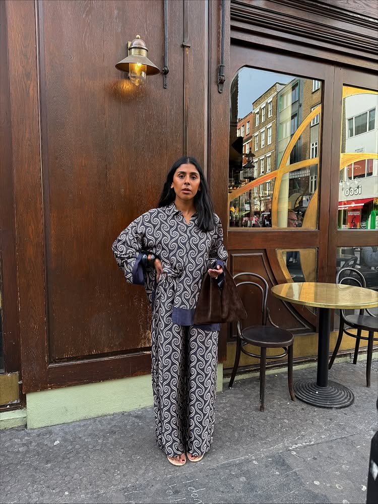 An image of @monikh wearing a matching silk set from Faithful The Label with a suede bag.