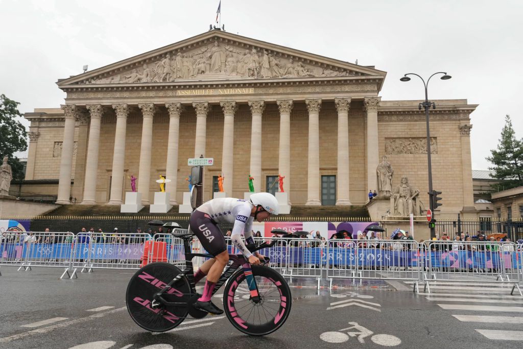 US' Chloe Dygert cycles past the National Assembly as she competes in the women's road cycling individual time trial during the Paris 2024 Olympic Games in Paris, on July 27, 2024. (Photo by Dimitar DILKOFF / AFP)
