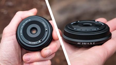 The tiny Viltrox AF 28mm F4.5 lens nestled in user's hand