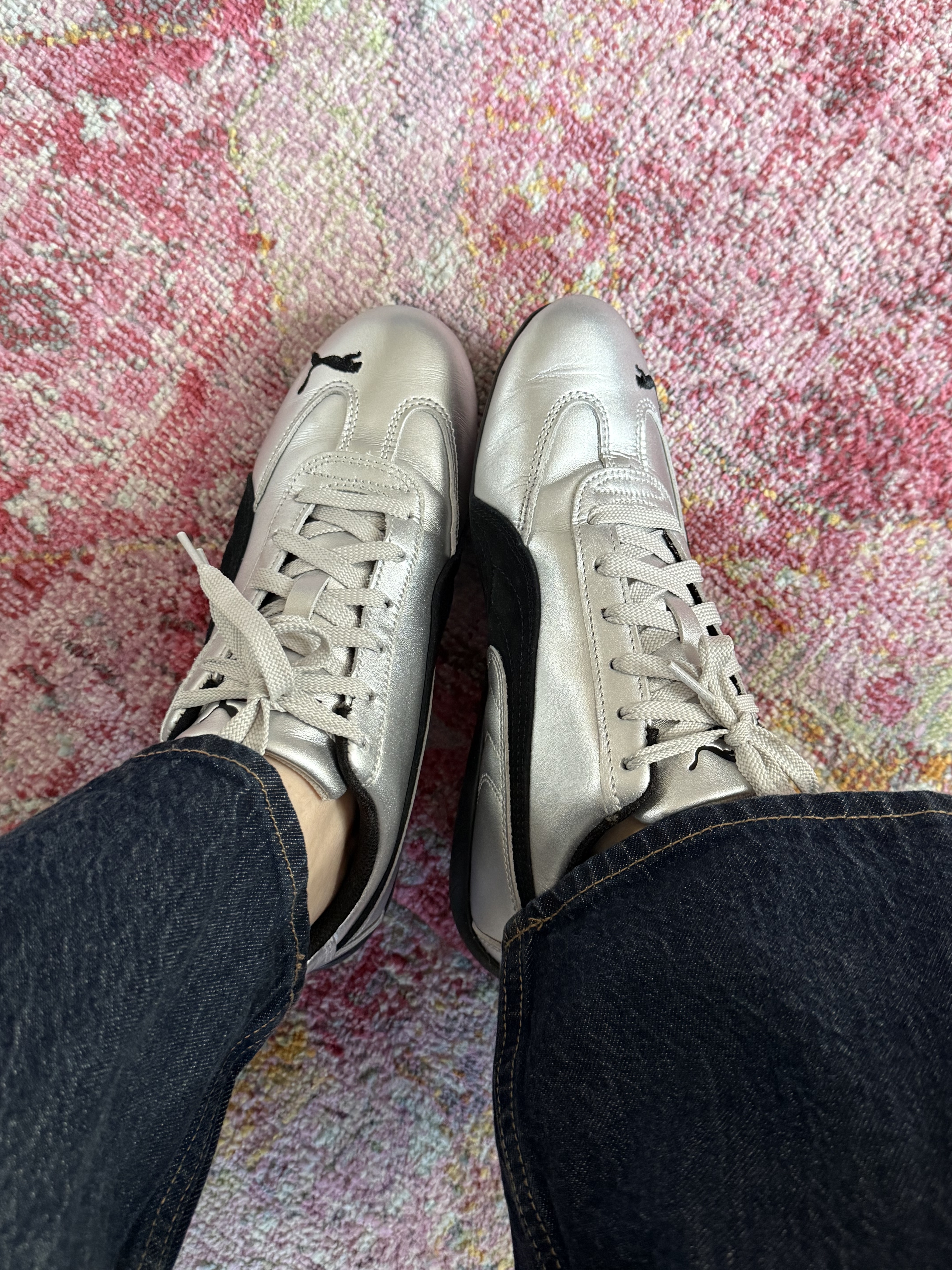 silver lack pume speedcat sneakers on pink patterned rug