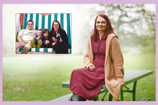 Anna Roberts sitting on a bench beside a picture of her family