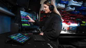 A woman using Shure's WAVETOOL 4 for audio production. 