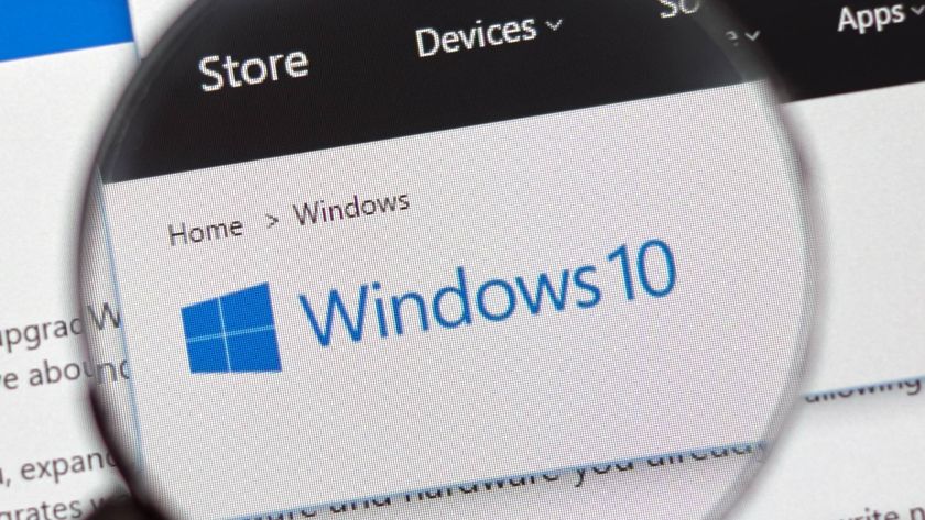 Windows 10 logo on screen shown in magnifying glass 
