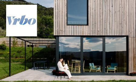 Woman sitting outside house she booked through vrbo