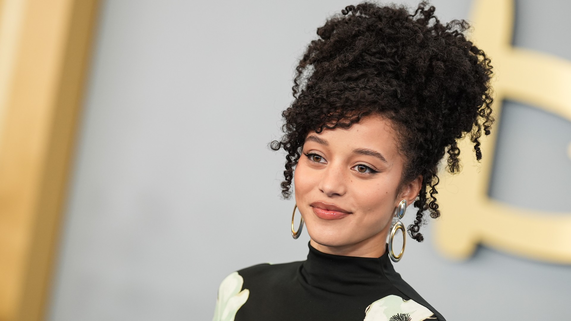 a young woman with dark, curly hair