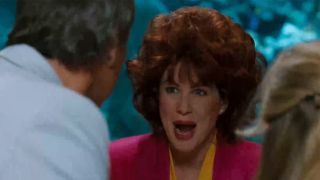 A woman with very big hair talking to Chevy Chase in Vegas Vacation