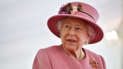 The queen in pink hat and outfit