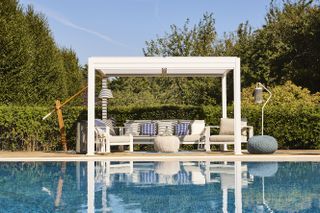 white pergola with outdoor living space, outdoor furniture