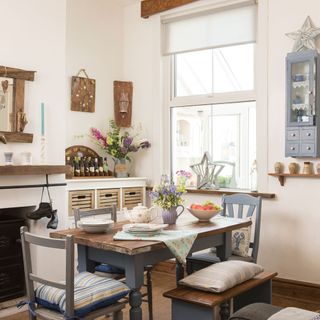 dining room with wooden dining set white walls and wooden flooring