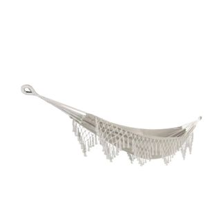 A white hammock with a decorative fringe