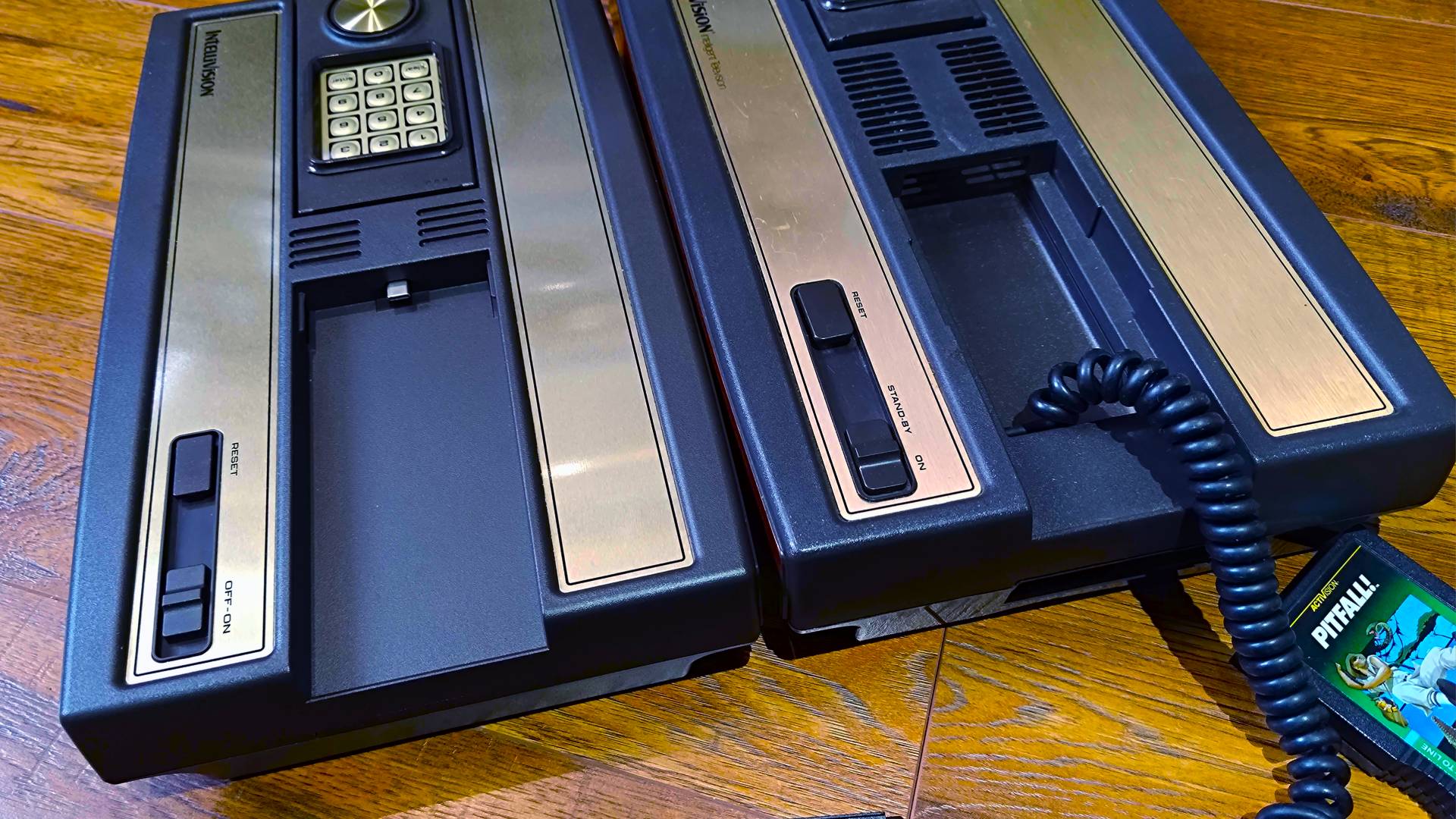 Intellivision Sprint controller dock close up with controller detached next to original console with coil gamepad cable slot.