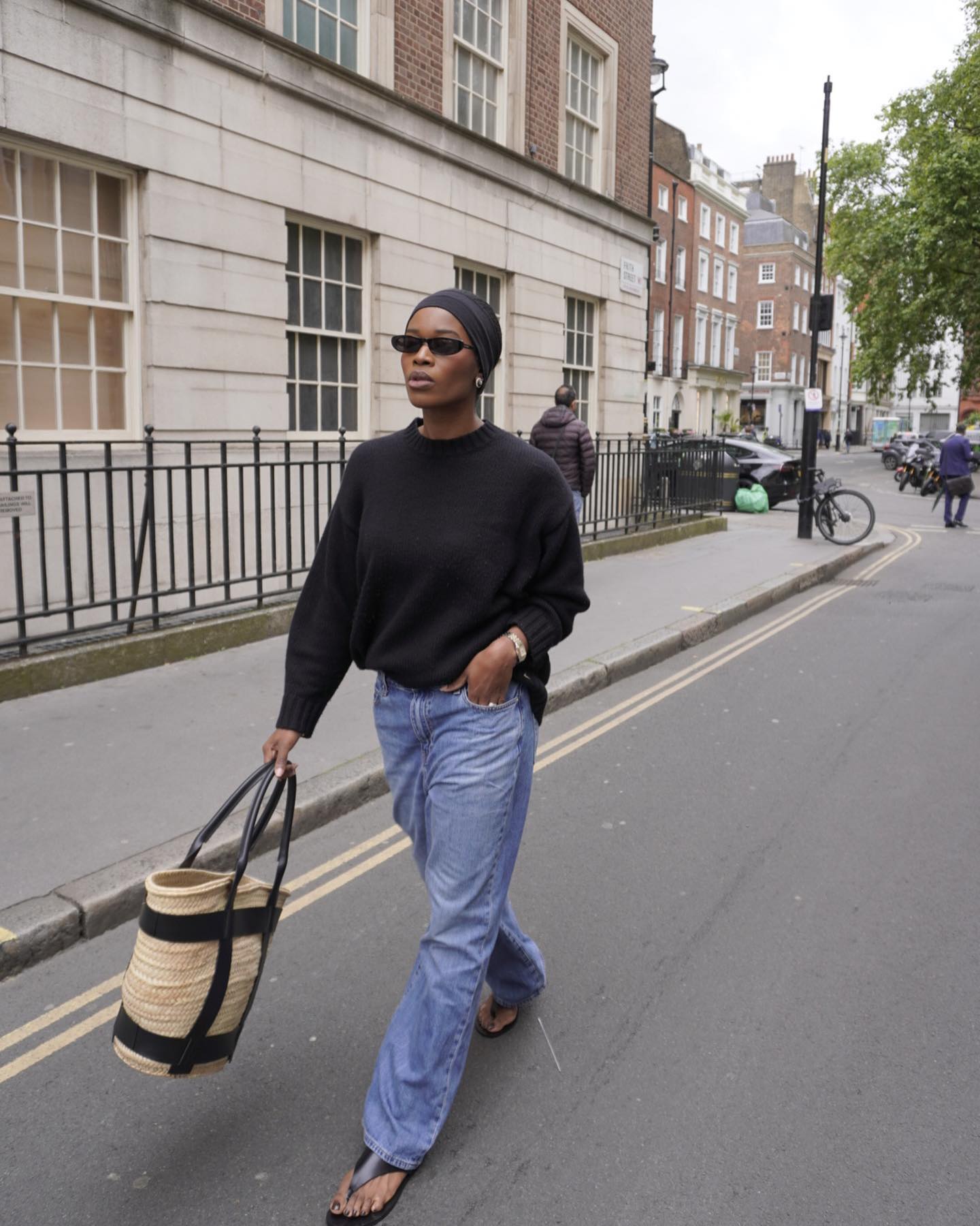 An image of @nlmarilyn wearing blue jeans with flip-flops.
