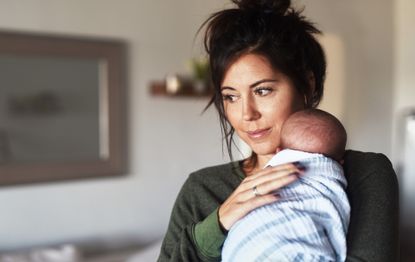 Smiling mother holding her baby