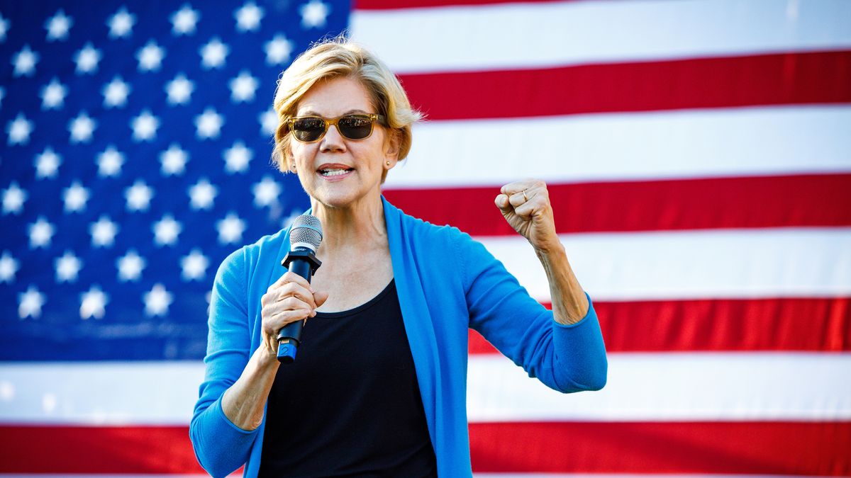 Senator Elizabeth Warren speaking in front of the US flag