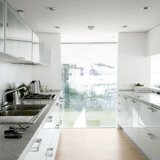 kitchen with white cabinet and wash basin