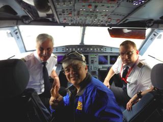 Space.com skywatching columnist Joe Rao poses with Capt. Joe Heinz and First Officer Dirk Pleimling in the cockpit of an eclipse-chasing jet chartered by AirEvents/Deutsche Polarflug and Eclipse-Reisen to follow the 2015 total solar eclipse over the North Atlantic Ocean on March 20, 2015.