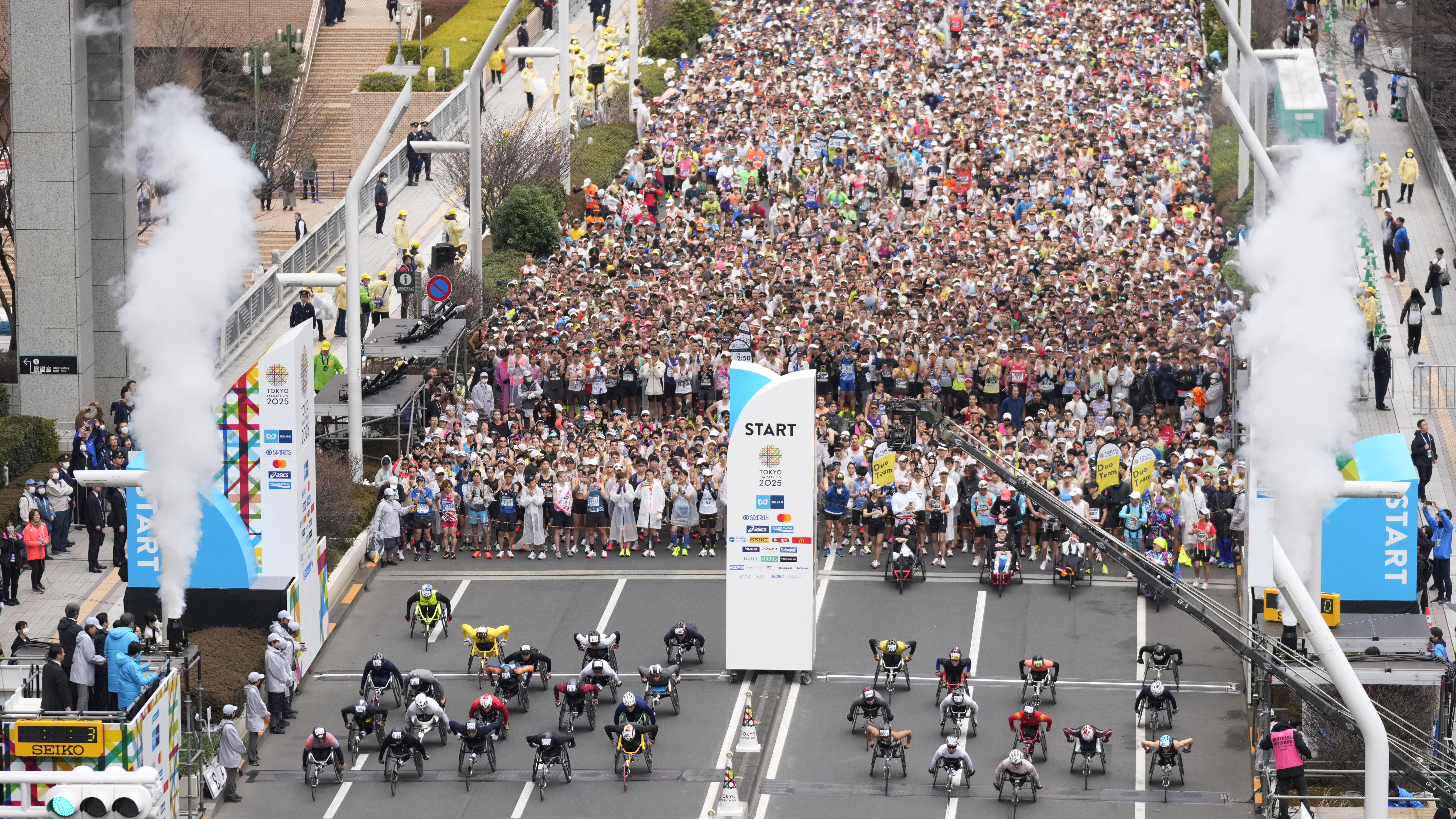 Wheelchair athletes start the Tokyo Marathon as they pass the Tokyo Metropolitan Government Building in the Shinjuku area of downtown Tokyo on March 2, 2025. 