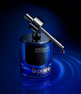 La Prairie Skin Caviar Nighttime oil in blue bottle inspired by Niki de Saint Phalle.