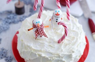 One of our favourite Christmas cake ideas and designs with royal icing, fondant snowmen and candy canes