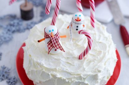 One of our favourite Christmas cake ideas and designs with royal icing, fondant snowmen and candy canes