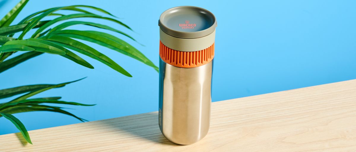 Wacaco Pipamoka portable coffee maker in front of a blue background. 