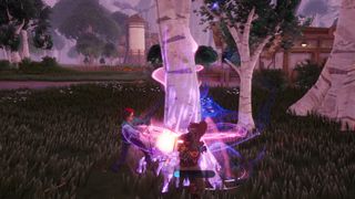 Palia - two players work together to chop down a tree with a glowing purple trunk