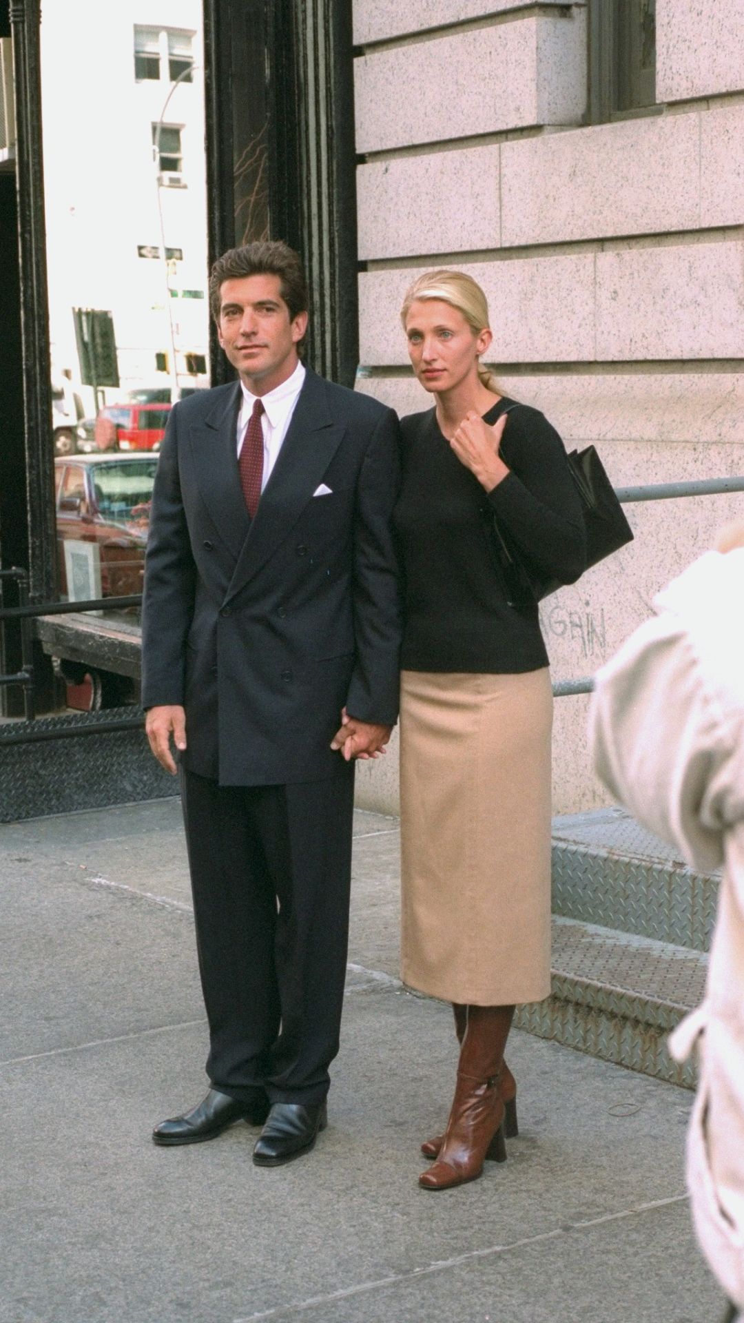 John F. Kennedy Jr. and bride Carolyn Bessette Kennedy stand in front of their apartment in Tribecca