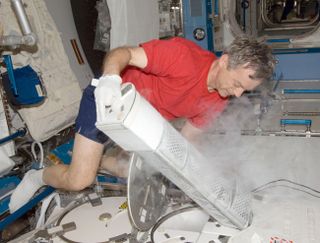 Canadian astronaut Robert Thirsk stores urine samples