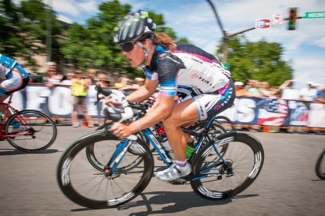 Kori Seehafer (Primal) keeping a watchful eye of action just off the front while taking a high speed corner on to College Avenue.