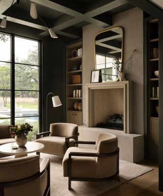 living room with dark green walls, neutral decor and large windows