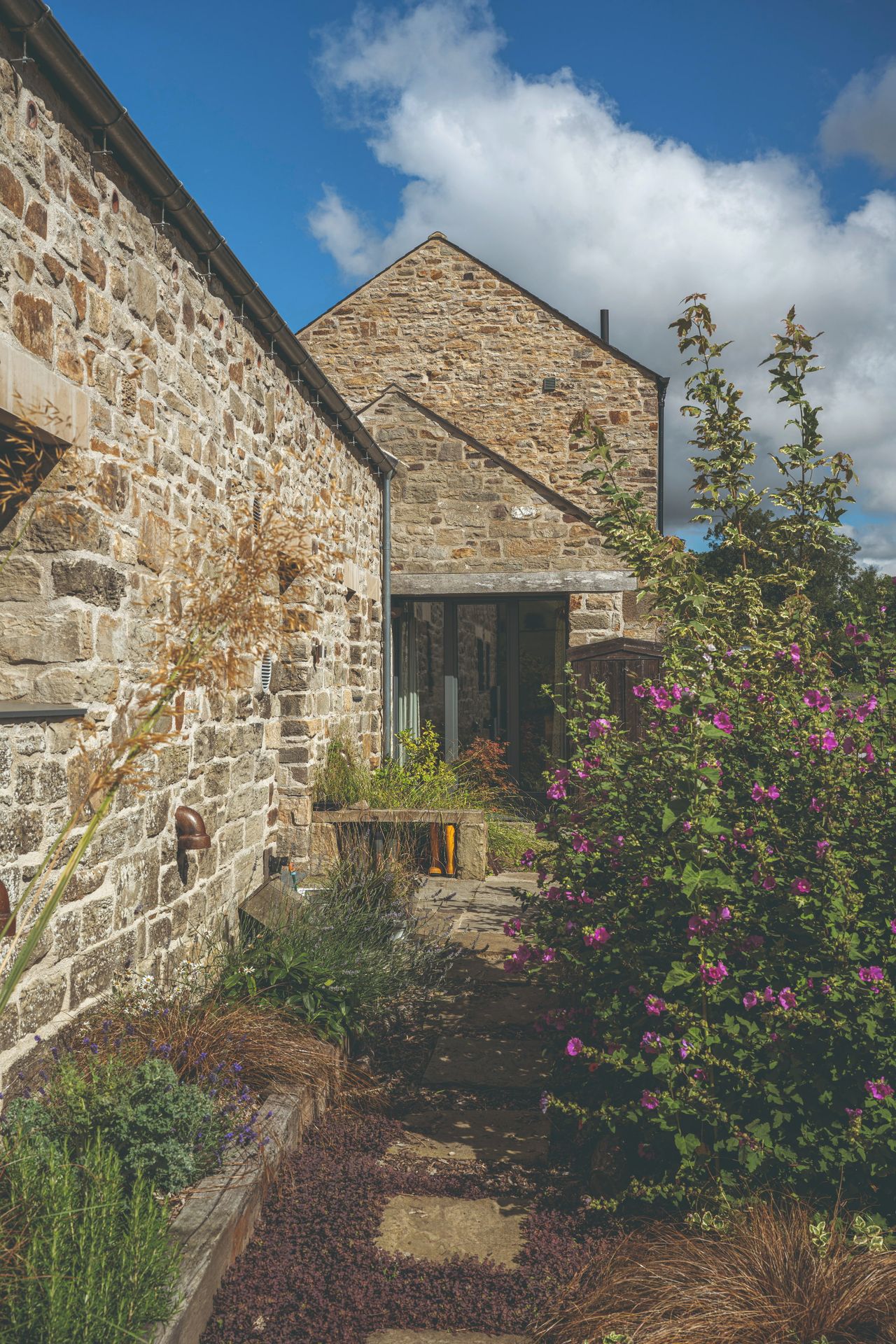 A stone barn conversion with bifold doors and wellington boot storage