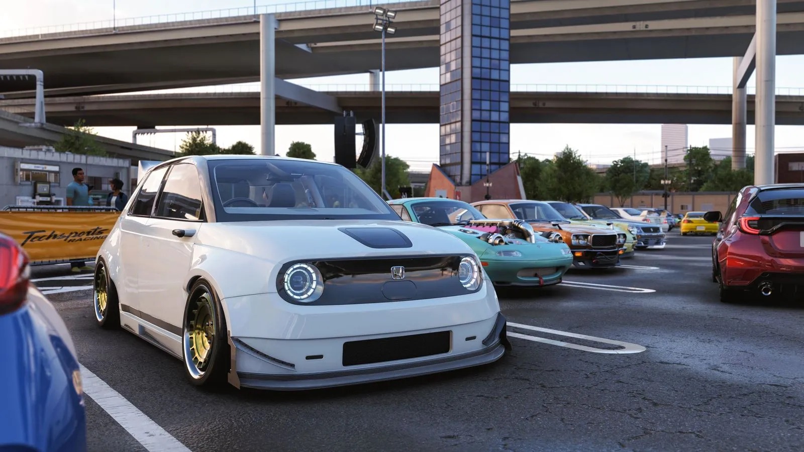 Modified white Honda car with custom wheels parked among colorful cars in a lot beneath an overpass, conveying a lively, urban auto-show vibe.