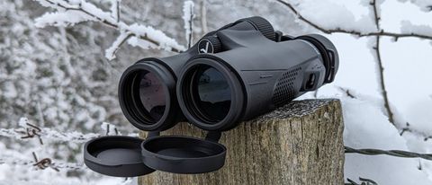 Front view of the Encalife SVBONY SV47 10x42 binoculars on a snowy post