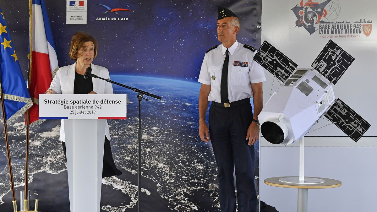 French Minister of Defense Florence Parly (left) discusses the new French space force in a speech at Airbase 942 in Lyon-Mont Verdun, on July 25, 2019. Next to her on stage, French Air Force general Philippe Lavigne stands beside a model of a satellite.