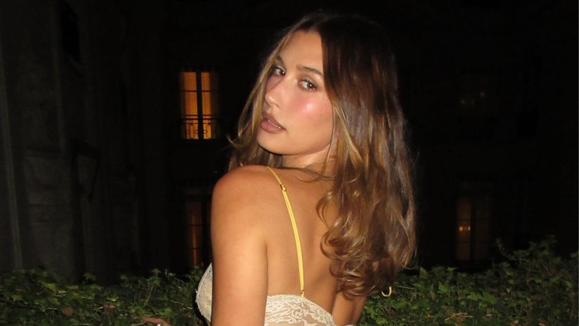 Hailey Bieber posing for a photo at Paris Fashion Week.