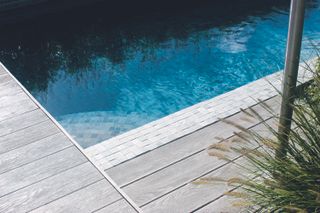 garden design with real wood decking by a pool