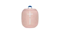 The ue wonderboom 2 bluetooth speaker in light pink with white buttons