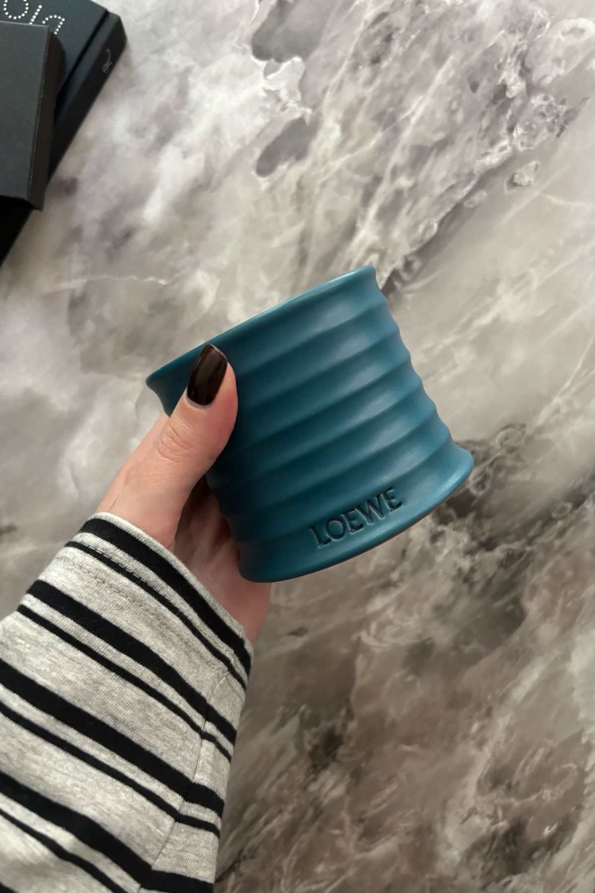 Deputy beauty editor Grace Lindsay holding the Loewe Incense candle