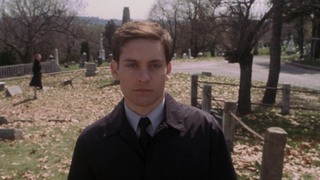 Tobey Maguire as Peter Parker walking in cemetery in Spider-Man