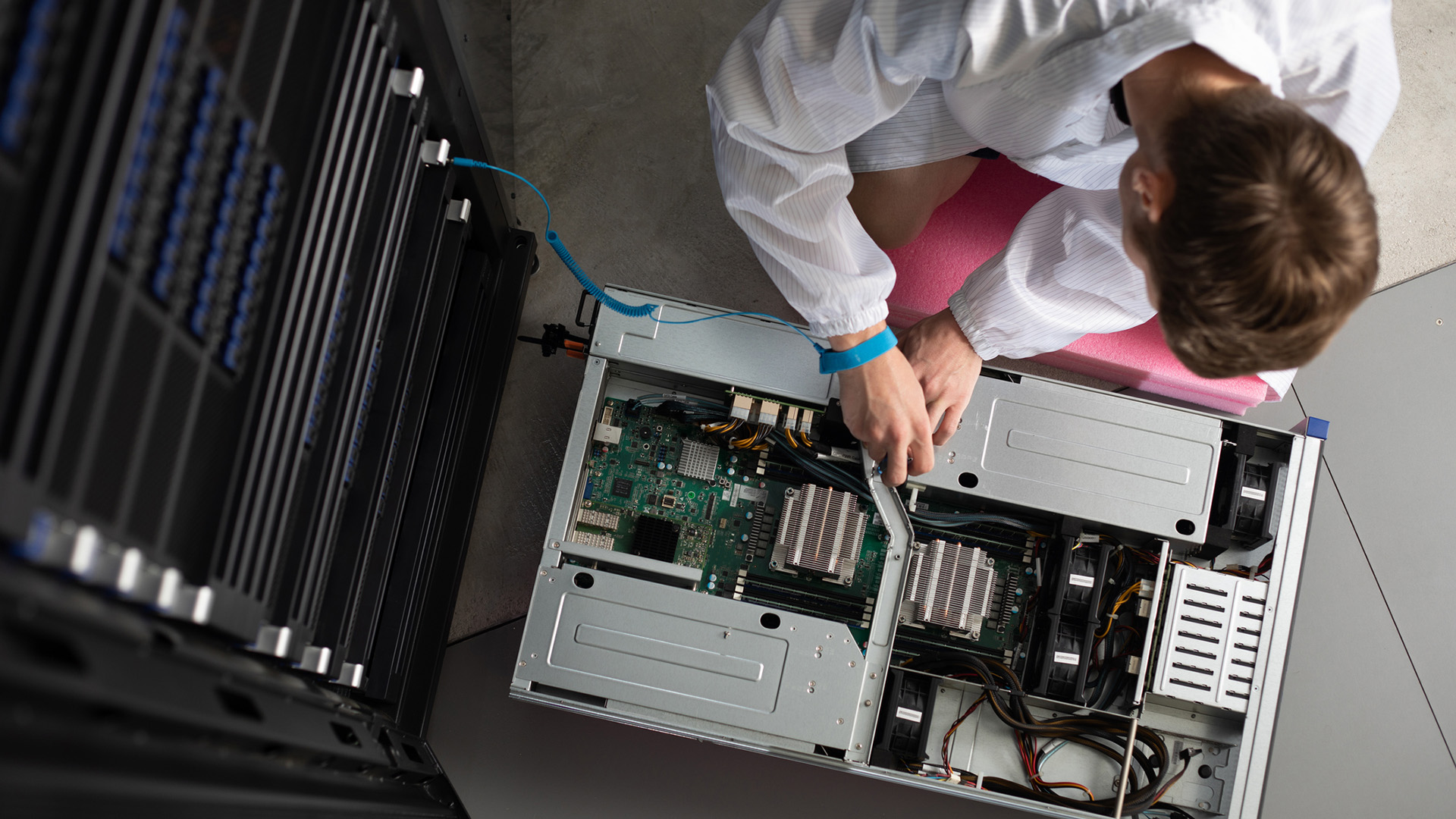 A technician servicing a rack-mounted node within a supercomputer.