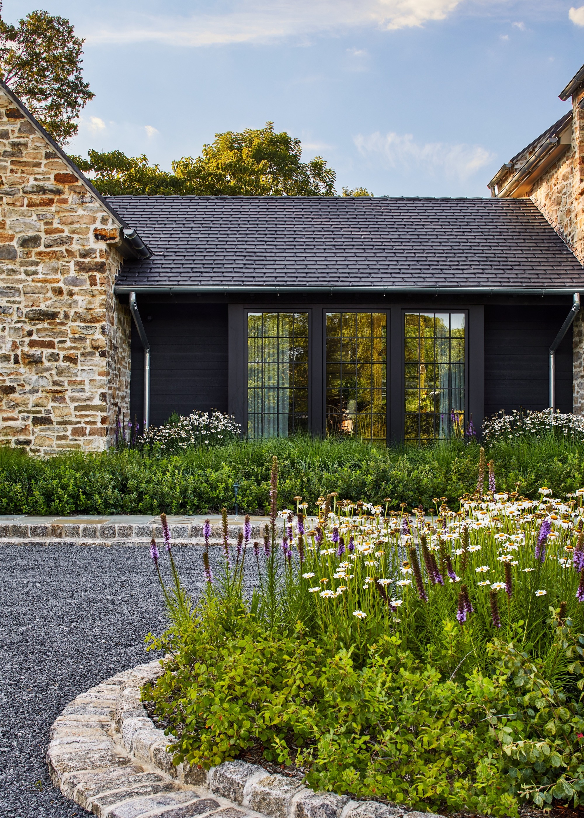 property with permeable driveway and pretty plantings