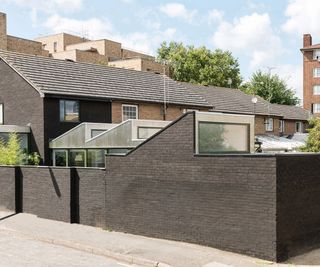 garage conversion with three sloped roof sections leading from garage to house