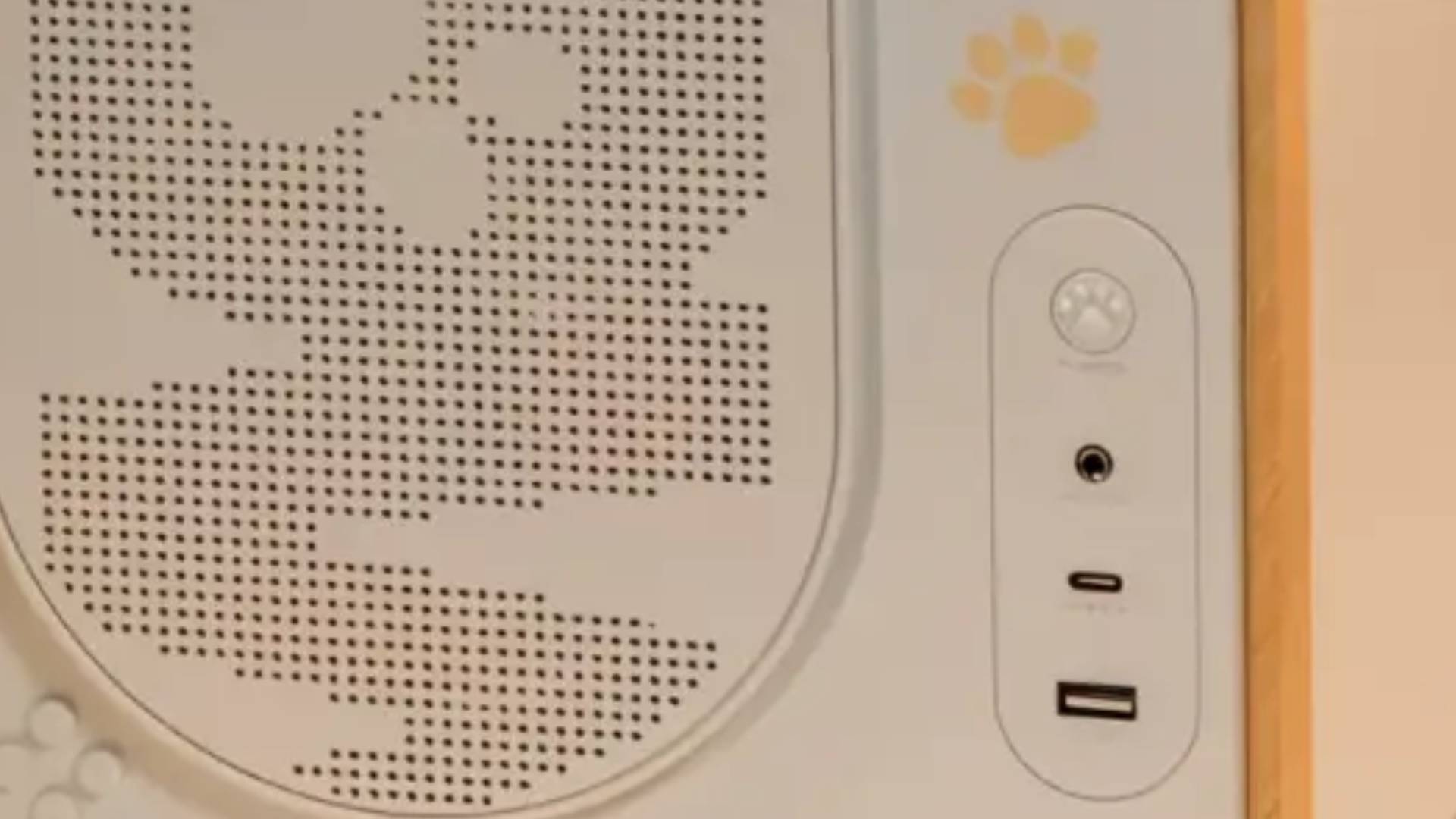 A zoomed in look at the front of the ME26A PC case's cat paw power button detailing.