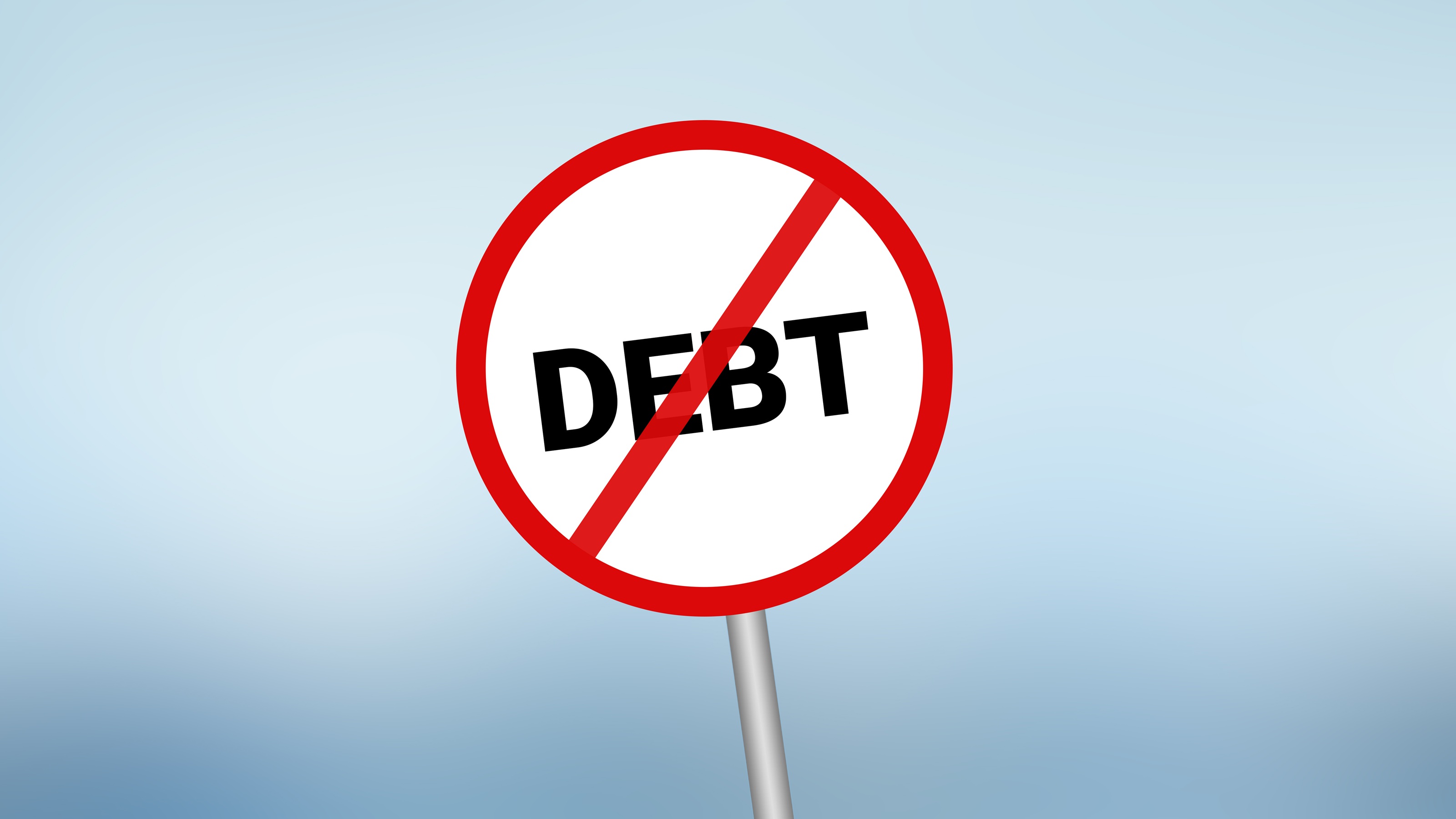 A sign that says "debt" inside a red circle with a slash through it, against a blue background.